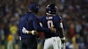 Sep 26, 2025; Charlottesville, Virginia, USA; Virginia Cavaliers head coach Tony Elliott (L) watches a video review of a called targeting penalty on Cavaliers safety Antonio Clary (0) against the Florida State Seminoles during the second quarter at Scott Stadium. Mandatory Credit: Geoff Burke-Imagn Images