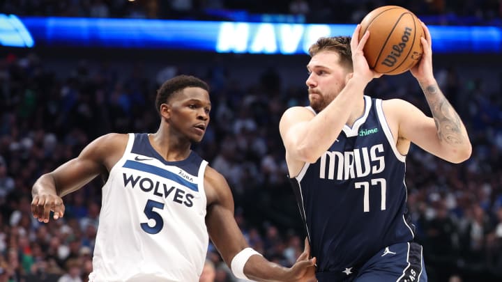 May 28, 2024; Dallas, Texas, USA; Dallas Mavericks guard Luka Doncic (77) dribbles against Minnesota Timberwolves guard Anthony Edwards (5) during the third quarter of game four of the western conference finals for the 2024 NBA playoffs at American Airlines Center. Mandatory Credit: Kevin Jairaj-USA TODAY Sports