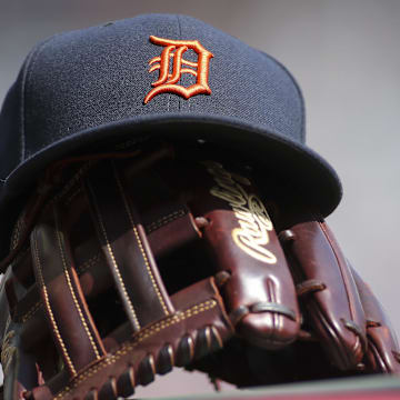 Detroit Tigers hat and glove are seen in the dugout