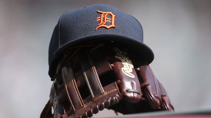 Detroit Tigers hat and glove are seen in the dugout