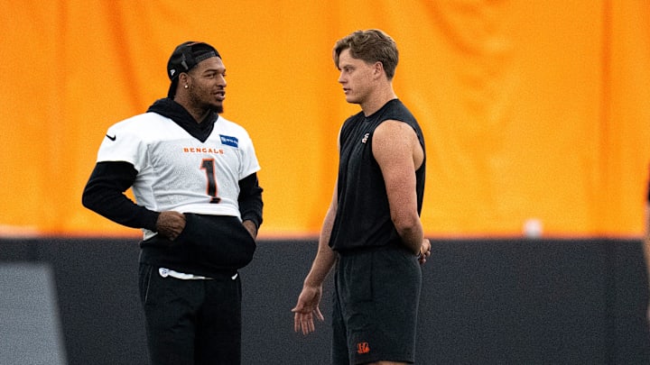 Cincinnati Bengals wide receiver Ja'Marr Chase (1) and Cincinnati Bengals quarterback Joe Burrow (9) talk at Bengals spring practice at the IEL Indoor Facility in Cincinnati on Thursday, June 13, 2024.