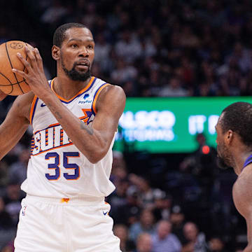 Apr 12, 2024; Sacramento, California, USA; Phoenix Suns forward Kevin Durant (35) controls the ball against Sacramento Kings forward Harrison Barnes (40) during the second quarter at Golden 1 Center. Mandatory Credit: Ed Szczepanski-Imagn Images