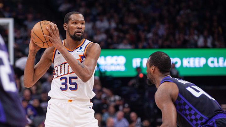 Apr 12, 2024; Sacramento, California, USA; Phoenix Suns forward Kevin Durant (35) controls the ball against Sacramento Kings forward Harrison Barnes (40) during the second quarter at Golden 1 Center. Mandatory Credit: Ed Szczepanski-Imagn Images