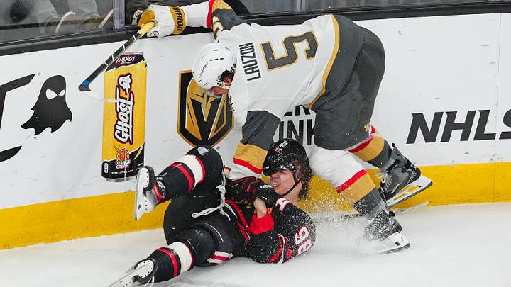 Mar 14, 2026; Las Vegas, Nevada, USA; Vegas Golden Knights defenseman Jeremy Lauzon (5) checks Chicago Blackhawks center Connor Bedard (98) during the third period at T-Mobile Arena. Mandatory Credit: Stephen R. Sylvanie-Imagn Images