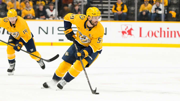 Jan 14, 2025; Nashville, Tennessee, USA;  Nashville Predators defenseman Roman Josi (59) skates with the puck against the Vegas Golden Knights during the third period at Bridgestone Arena. Mandatory Credit: Steve Roberts-Imagn Images