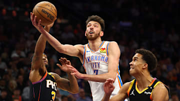 Apr 9, 2025; Phoenix, Arizona, USA; Oklahoma City Thunder forward Chet Holmgren (7) shoots the ball over Phoenix Suns guard Bradley Beal (3) and center Bol Bol (11) during the second half at Footprint Center. Mandatory Credit: Mark J. Rebilas-Imagn Images