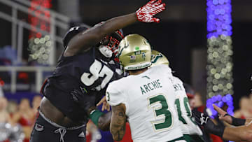 Nov 1, 2024; Boca Raton, Florida, USA;  Florida Atlantic Owls defensive lineman Devonta Davis (97) tries to block a pass from South Florida Bulls quarterback Bryce Archie (3) during the second quarter at FAU Stadium. Mandatory Credit: Reinhold Matay-Imagn Images
