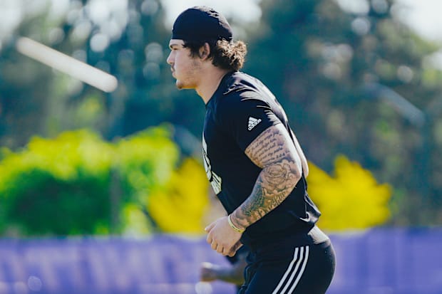 Zach Durfee goes through rehab exercises during each spring practice, but doesn't mix in with the Huskies.