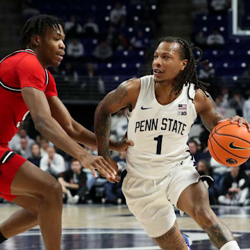 Jan 20, 2025; University Park, Pennsylvania, USA; Penn State Nittany Lions guard Ace Baldwin Jr (1) dribbles the ball around the outside of Rutgers Scarlet Knights forward Dylan Grant (9) during the first half at Bryce Jordan Center. Penn State defeated Rutgers 80-72. Mandatory Credit: Matthew O'Haren-Imagn Images