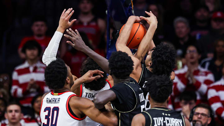 Jan 11, 2025; Tucson, Arizona, USA; Arizona Wildcats forward Trey Townsend (4) and UCF Knights guard Dallan ‘Deebo’ Coleman (6) both reach to rebound the ball during the first half of the game at McKale Center. Mandatory Credit: Aryanna Frank-Imagn Images
