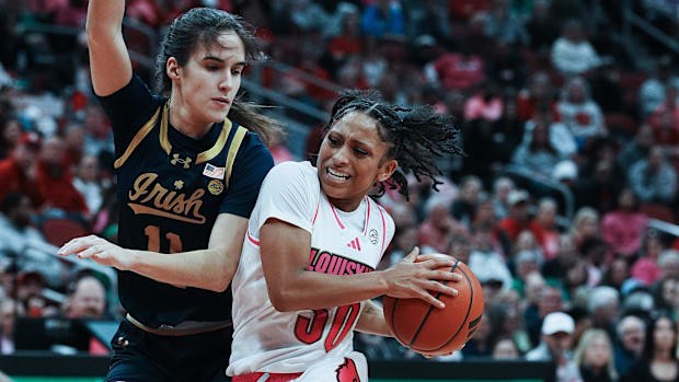 Louisville's Jayda Curry (30) drives against Notre Dame's 	Sonia Citron (11) during their game at the KFC Yum! Center