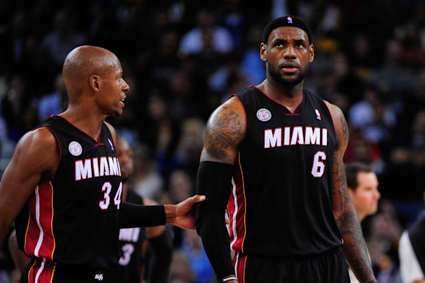 Miami Heat shooting guard Ray Allen (34) restrains small forward LeBron James (6)
