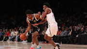 Apr 1, 2025; Brooklyn, NY, USA; McDonald's All American East forward Jalen Haralson (4) dribbles the ball against McDonald's All American West guard Darryn Peterson (22) during the second half of the game at Barclays Center. Mandatory Credit: Pamela Smith-Imagn Images