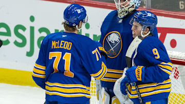 Jan 9, 2025; Ottawa, Ontario, CAN; Buffalo Sabres center Ryan McLeod (71) celebrates with goalie Ukko-Pekka Luukkonen (1) and left wing Zach Benson (9) their win against the Ottawa Senators at the Canadian Tire Centre. Mandatory Credit: Marc DesRosiers-Imagn Images