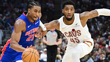 Oct 25, 2024; Cleveland, Ohio, USA; Detroit Pistons guard Jaden Ivey (23) drives to the basket against Cleveland Cavaliers guard Donovan Mitchell (45): Ken Blaze-Imagn Images