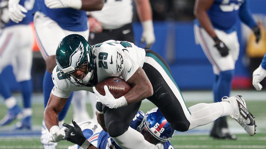 Oct 9, 2025; East Rutherford, New Jersey, USA; Philadelphia Eagles running back AJ Dillon (29) avoids a tackle by New York Giants linebacker Bobby Okereke (58) during the fourth quarter of the game at MetLife Stadium. Mandatory Credit: Vincent Carchietta-Imagn Images