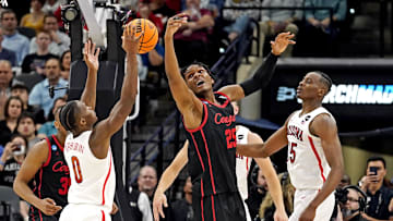 Mar 24, 2022; San Antonio, TX, USA; Arizona Wildcats guard Bennedict Mathurin (0) and Houston Cougars center Josh Carlton (25) go for the ball during the second half in the semifinals of the South regional of the men's college basketball NCAA Tournament at AT&T Center. Mandatory Credit: Scott Wachter-Imagn Images