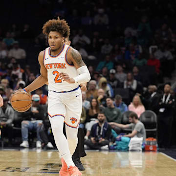 Mar 20, 2025; Charlotte, North Carolina, USA; New York Knicks guard Miles McBride (2) brings the ball up court against Charlotte Hornets guard LaMelo Ball (1)  during the first quarter at Spectrum Center. Mandatory Credit: Jim Dedmon-Imagn Images