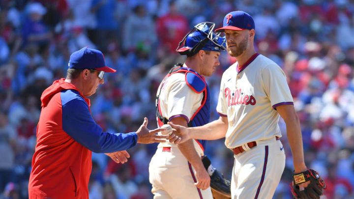 Apr 14, 2024; Philadelphia, Pennsylvania, USA; Philadelphia Phillies pitcher Zack Wheeler (45) hands the ball to manager Rob Thomson (59) after giving up a grands slam hime run against the Pittsburgh Pirates during the sixth inning at Citizens Bank Park.