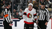 Jan 11, 2025; Pittsburgh, Pennsylvania, USA;  Ottawa Senators center Nick Cousins (21) protests to referee Tom Chmielewski (18) after being called for committing a penalty against the Pittsburgh Penguins during the second period at PPG Paints Arena. Mandatory Credit: Charles LeClaire-Imagn Images