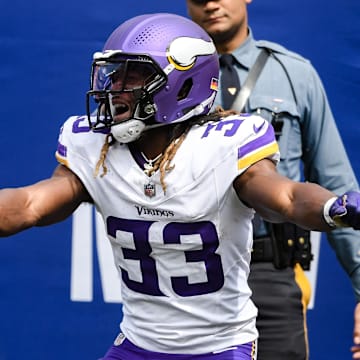 Sep 8, 2024; East Rutherford, New Jersey, USA; Minnesota Vikings running back Aaron Jones (33) celebrates after scoring a touchdown against the New York Giants during the first half at MetLife Stadium.