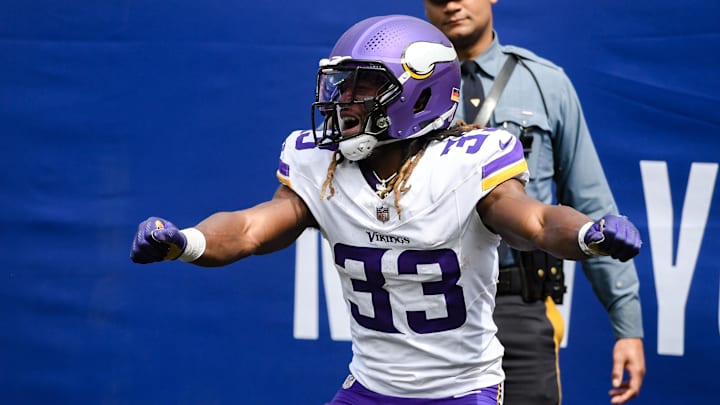 Sep 8, 2024; East Rutherford, New Jersey, USA; Minnesota Vikings running back Aaron Jones (33) celebrates after scoring a touchdown against the New York Giants during the first half at MetLife Stadium.