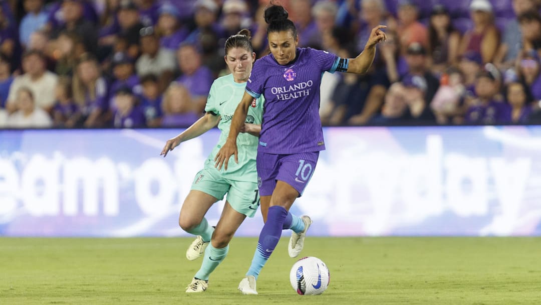 May 16, 2025; Orlando, Florida, USA; Orlando Pride forward Marta (10) dribbles the ball around Kansas City Current defender Izzy Rodriguez (18) during the first half at Inter&Co Stadium. Mandatory Credit: Morgan Tencza-Imagn Images