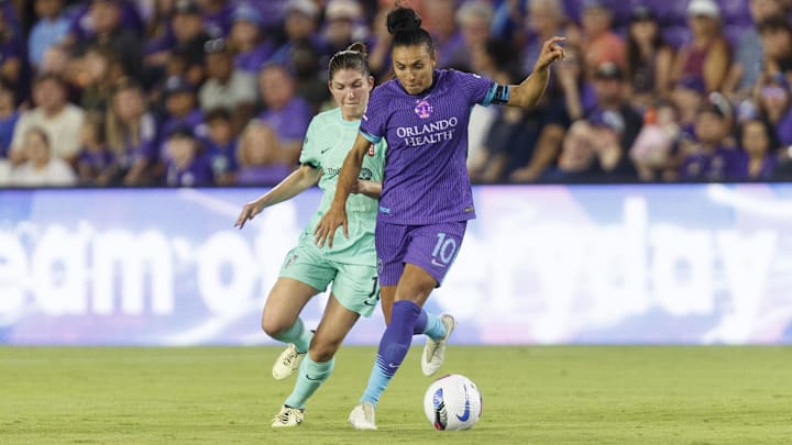 May 16, 2025; Orlando, Florida, USA; Orlando Pride forward Marta (10) dribbles the ball around Kansas City Current defender Izzy Rodriguez (18) during the first half at Inter&Co Stadium. Mandatory Credit: Morgan Tencza-Imagn Images
