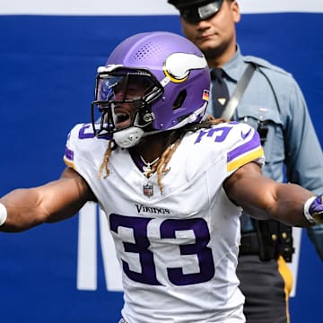 Sep 8, 2024; East Rutherford, New Jersey, USA; Minnesota Vikings running back Aaron Jones (33) celebrates after scoring a touchdown against the New York Giants during the first half at MetLife Stadium. Mandatory Credit: John Jones-Imagn Images