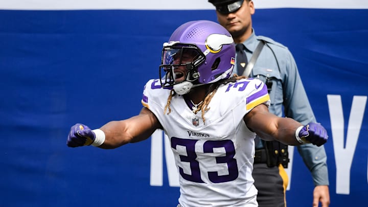 Sep 8, 2024; East Rutherford, New Jersey, USA; Minnesota Vikings running back Aaron Jones (33) celebrates after scoring a touchdown against the New York Giants during the first half at MetLife Stadium. Mandatory Credit: John Jones-Imagn Images