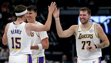 Oct 31, 2025; Memphis, Tennessee, USA; Los Angeles Lakers guard Luka Doncic (77) reacts with guard Austin Reaves (15) during a timeout during the second quarter against the Memphis Grizzlies at FedExForum. Mandatory Credit: Petre Thomas-Imagn Images
