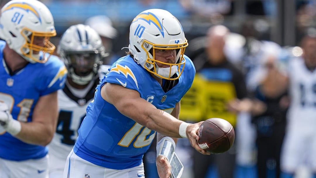 Sep 15, 2024; Charlotte, North Carolina, USA; Los Angeles Chargers quarterback Justin Herbert (10) hands off during the second half against the Carolina Panthers at Bank of America Stadium. Mandatory Credit: Jim Dedmon-Imagn Images