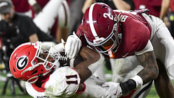 Sep 28, 2024; Tuscaloosa, Alabama, USA;  Georgia Bulldogs wide receiver Arian Smith (11) is tackled by Alabama Crimson Tide defensive back Zabien Brown (2) after a long reception to set up a touchdown at Bryant-Denny Stadium. Alabama defeated Georgia 41-34. Mandatory Credit: Gary Cosby Jr.-Imagn Images