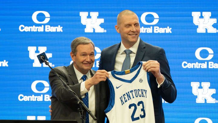 University of Kentucky Athletic Director Mitch Barnhart and new men’s basketball coach Mark Pope hold a new basketball jersey up during Pope’s press conference on Sunday, April 14, 2024.