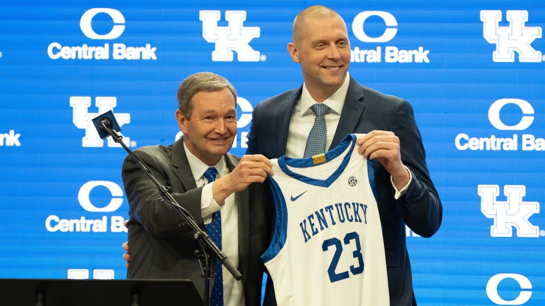 University of Kentucky Athletic Director Mitch Barnhart and new men’s basketball coach Mark Pope hold a new basketball jersey up during Pope’s press conference on Sunday, April 14, 2024.