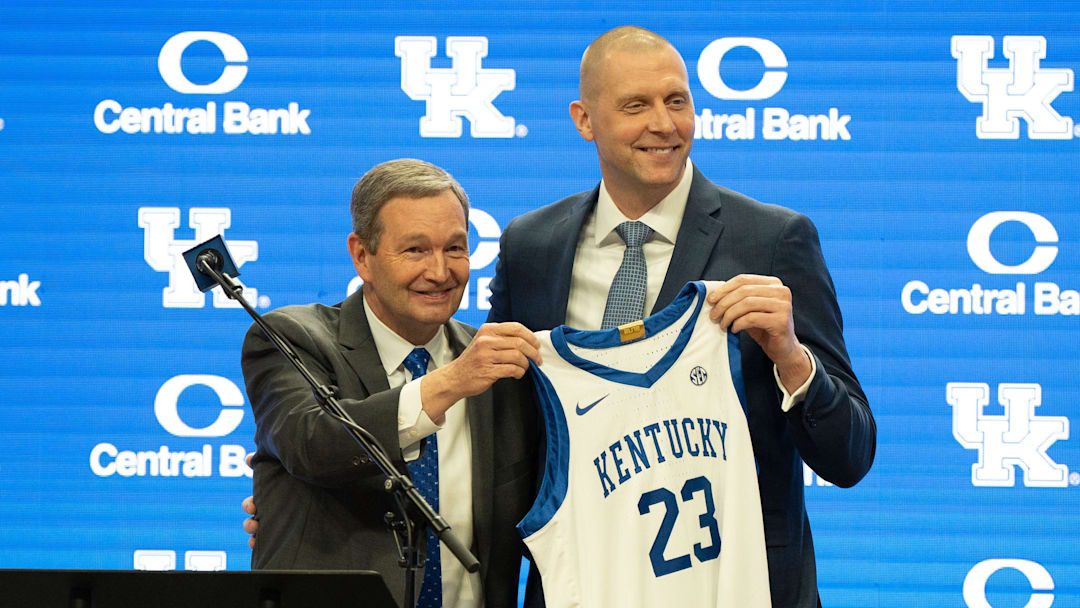 University of Kentucky Athletic Director Mitch Barnhart and new men’s basketball coach Mark Pope hold a new basketball jersey up during Pope’s press conference on Sunday, April 14, 2024.