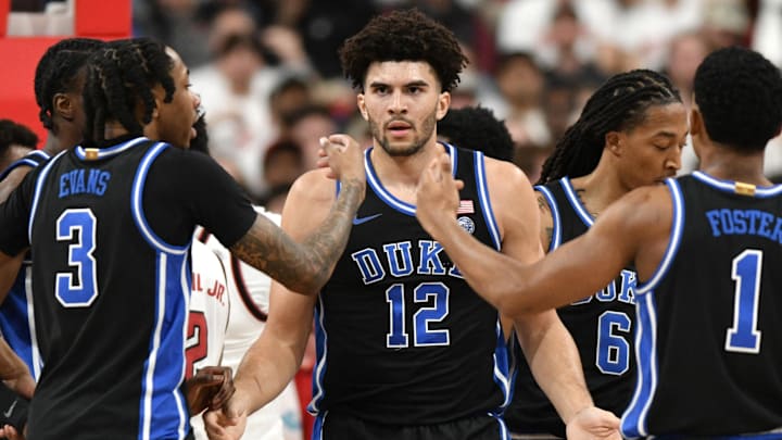 Mar 2, 2026; Raleigh, North Carolina, USA;  Duke Blue Devils forward Cameron Boozer (12) reacts with guard Isaiah Evans (3) and guard Caleb Foster (1) playing against the NC State Wolfpack.