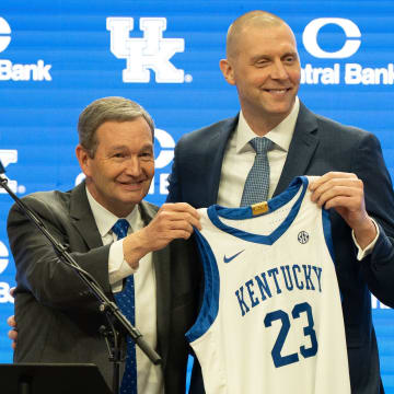 University of Kentucky Athletic Director Mitch Barnhart and new men’s basketball coach Mark Pope hold a new basketball jersey up during Pope’s press conference on Sunday, April 14, 2024.