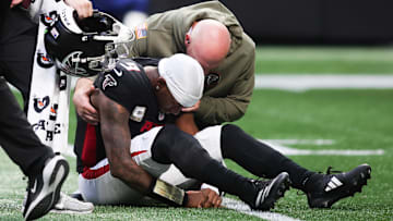 Nov 16, 2025; Atlanta, Georgia, USA; Atlanta Falcons quarterback Michael Penix Jr. (9) is attended to by medical staff in the third quarter against the Carolina Panthers at Mercedes-Benz Stadium.