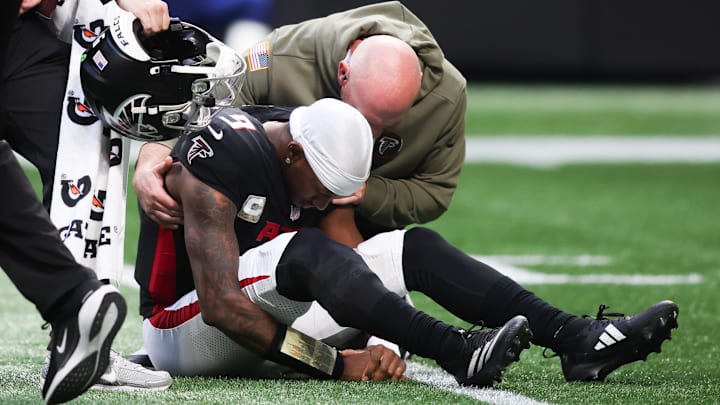 Nov 16, 2025; Atlanta, Georgia, USA; Atlanta Falcons quarterback Michael Penix Jr. (9) is attended to by medical staff in the third quarter against the Carolina Panthers at Mercedes-Benz Stadium.