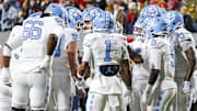 Nov 29, 2025; Raleigh, North Carolina, USA; North Carolina Tar Heels huddles during the first half of the game against NC State Wolfpack at Carter-Finley Stadium.  Mandatory Credit: Jaylynn Nash-Imagn Images