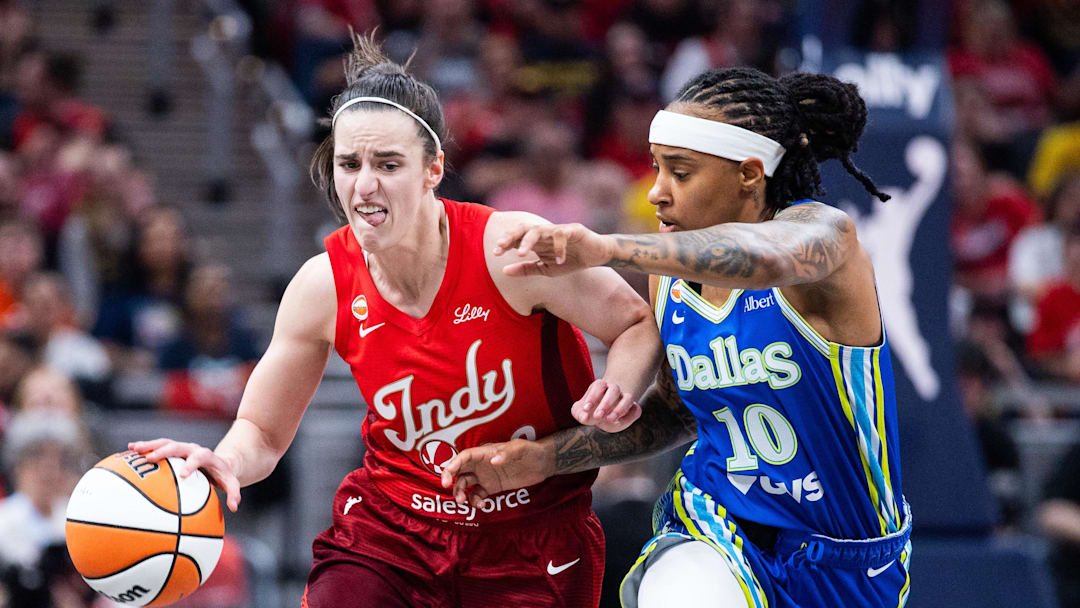 May 9, 2026; Indianapolis, Indiana, USA; Indiana Fever guard Caitlin Clark (22) dribbles the ball while Dallas Wings guard Aziaha James (10) defends in the first half at Gainbridge Fieldhouse. Mandatory Credit: Trevor Ruszkowski-Imagn Images