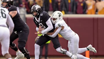Oct 28, 2023; Minneapolis, Minnesota, USA; Minnesota Golden Gophers quarterback Athan Kaliakmanis (8) is sacked by Michigan State Spartans linebacker Jordan Hall (5) during the first quarter at Huntington Bank Stadium. Mandatory Credit: Nick Wosika-Imagn Images