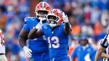Nov 29, 2025; Gainesville, Florida, USA; Florida Gators running back Jadan Baugh (13) gestures with Florida Gators offensive lineman Daniel Pierre-Louis (73) against the Florida State Seminoles during the first half at Ben Hill Griffin Stadium. Mandatory Credit: Matt Pendleton-Imagn Images