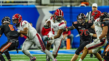 Orchard Lake St. Mary’s WR Bryson Williams (4) breaks through Byron Center’s defensive line during the first half of the Michigan High School Athletic Association division two football finals at Ford Field in Detroit on Friday, Nov. 29, 2024.