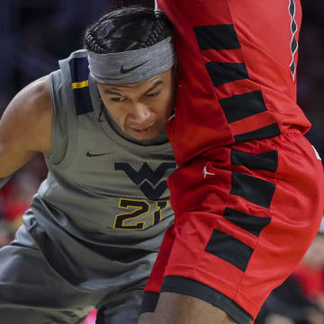 Mar 9, 2024; Cincinnati, Ohio, USA; West Virginia Mountaineers guard RaeQuan Battle (21) dribbles against the Cincinnati Bearcats in the second half at Fifth Third Arena. Mandatory Credit: Katie Stratman-USA TODAY Sports