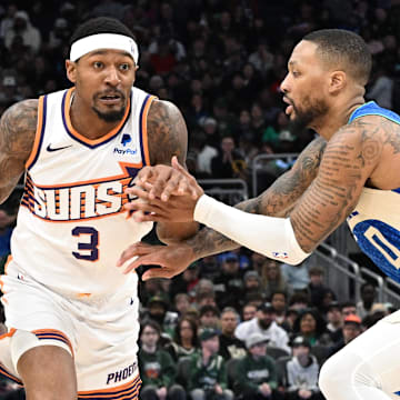 Mar 17, 2024; Milwaukee, Wisconsin, USA; Phoenix Suns guard Bradley Beal (3) drives against Milwaukee Bucks guard Damian Lillard (0) on the second half at Fiserv Forum. Mandatory Credit: Michael McLoone-Imagn Images