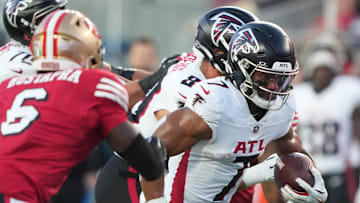 Oct 19, 2025; Santa Clara, California, USA; Atlanta Falcons running back Bijan Robinson (7) runs the ball past San Francisco 49ers safety Malik Mustapha (6) during the second quarter at Levi's Stadium. Mandatory Credit: Darren Yamashita-Imagn Images