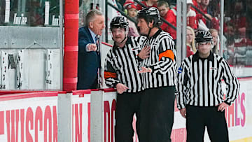 Wisconsin head coach Mark Johnson speaks with the referees during the end of the second period of the game against Ohio State on Saturday, Feb. 18, 2023, at LaBahn Arena in Madison, Wis.