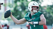 Louisville Cardinals quarterback Miller Moss during a morning practice Wednesday, July 30, 2025. Moss transferred from USC. His overall QB rating is 81.4. At left is UofL quarterbacks coach and offensive coordinator Brian Brohm.